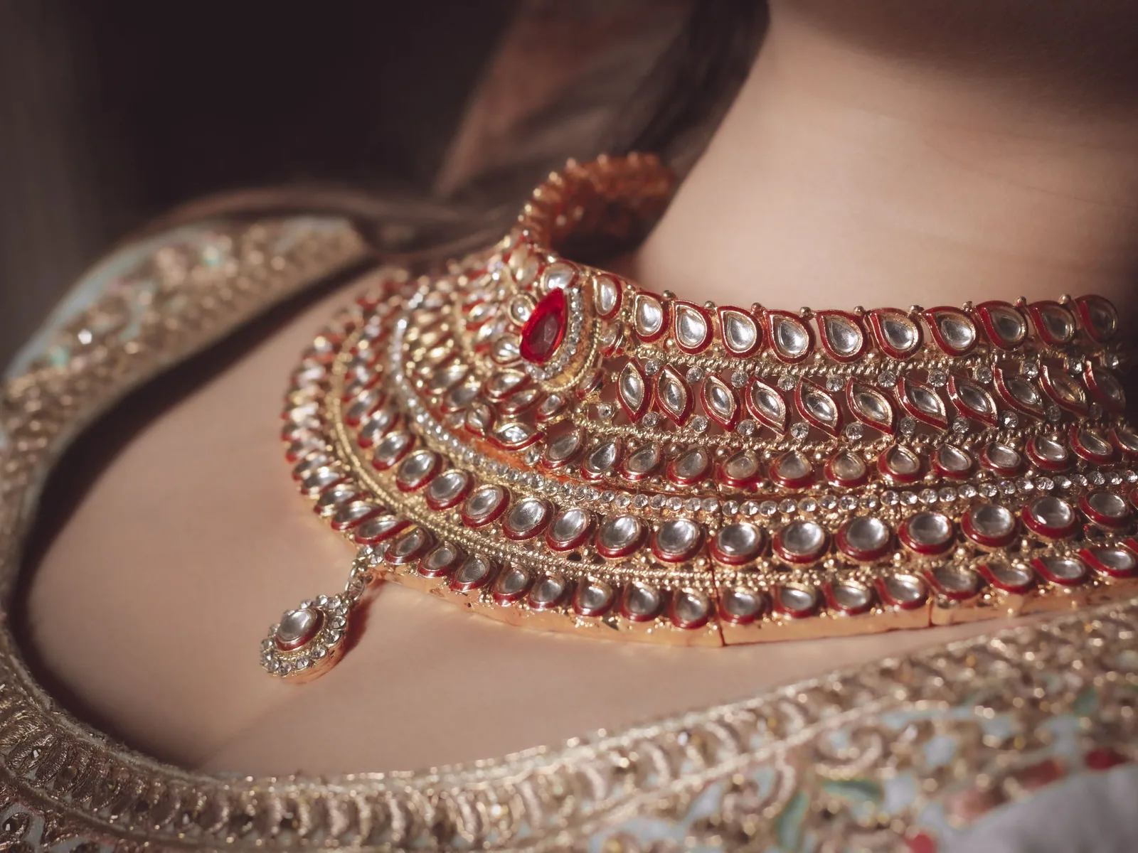 Bride photographed at the mandap with the venue softly out of focus behind her